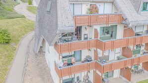 A multi-story building with balconies, a driveway, and a surrounding landscape. - View of Todtmoos with a Panoramic Balcony – My SWH (Todtmoos)