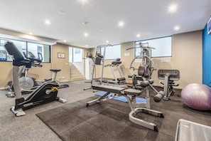 A gym with cardio machines, weightlifting equipment, and a large exercise ball. - Bay Street Terrace Spacious Indoor Outdoor Design (Port Melbourne)