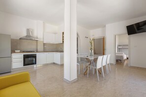 A modern kitchen with white cabinetry, a gas stove, and a built-in oven. - Attico Ilary by BarbarHouse (Gallipoli)