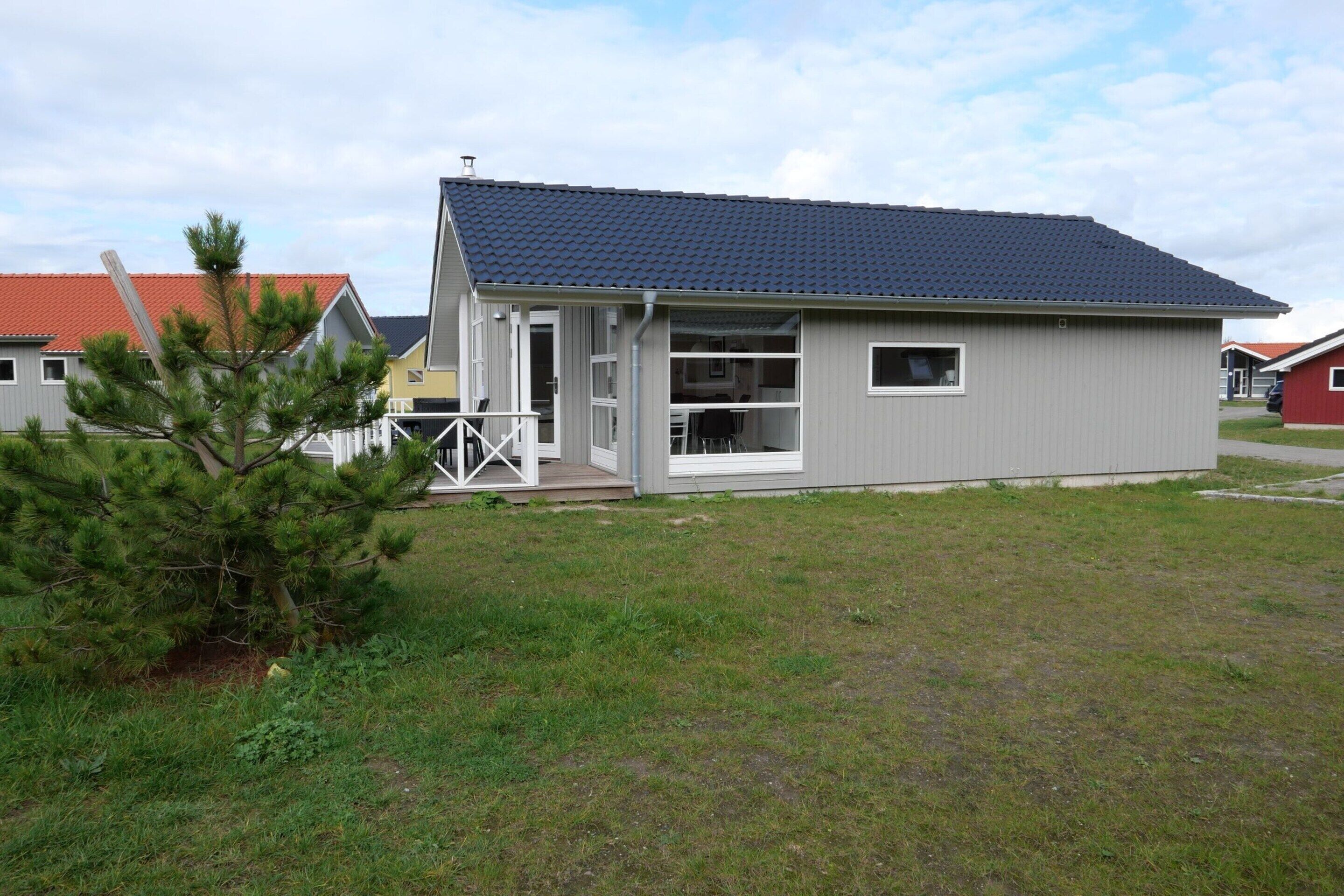 A small, single-story building with a flat roof and a covered porch.