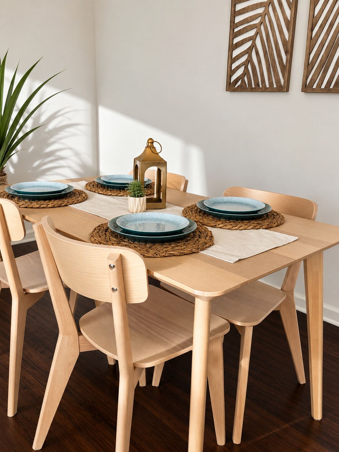 A dining area with a wooden table, six chairs, and decorative plates on woven placemats.