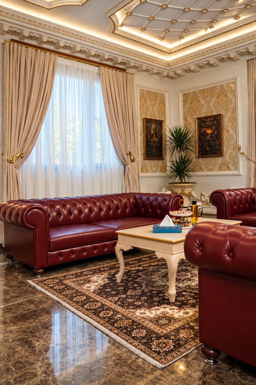 A luxurious room with a red leather sofa, a white coffee table, and a patterned rug.
