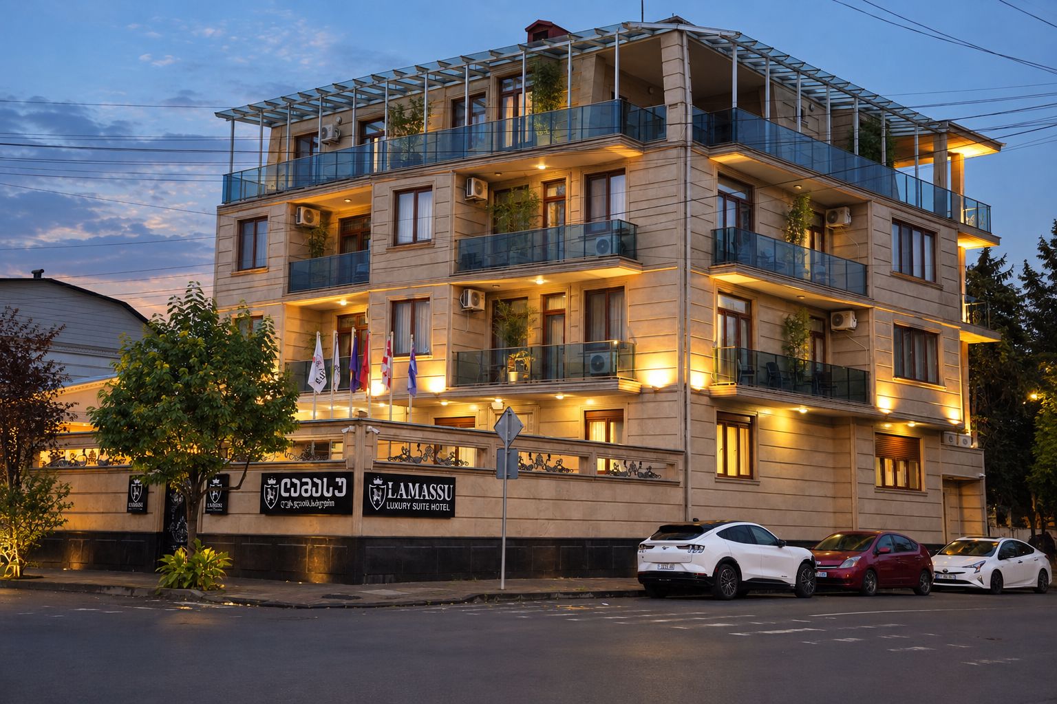 A multi-story hotel with balconies, flags, and a sign indicating it is a luxury suite hotel.