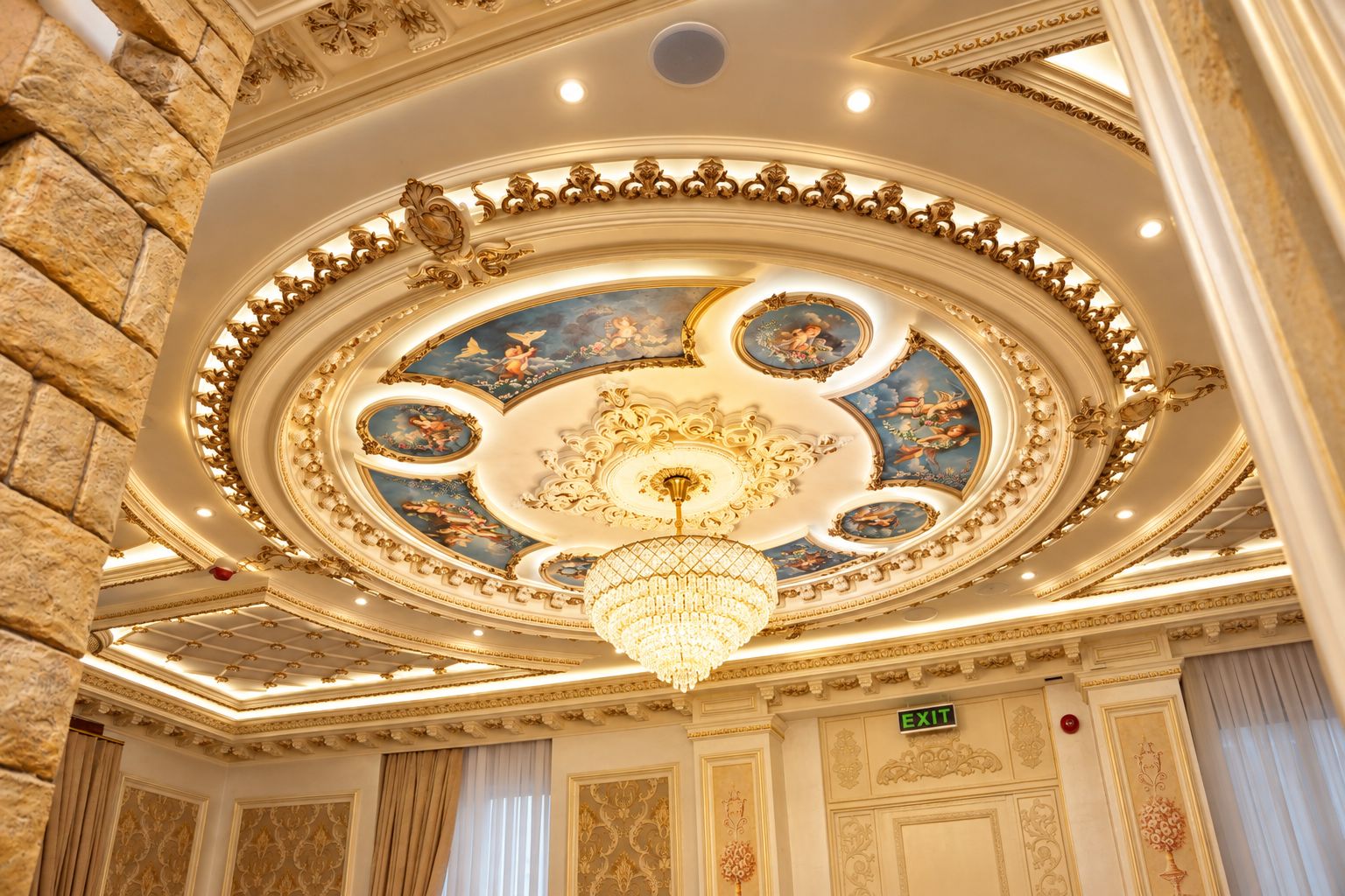 A grand ceiling with ornate gold detailing and a chandelier.