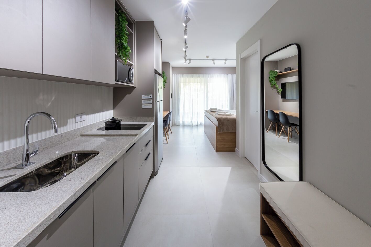 A modern kitchen with a built-in stove, a sink, and a countertop.