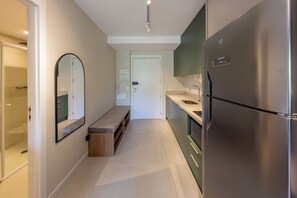 Eine moderne Küche mit einem Edelstahl-Kühlschrank, einem Einbauofen und einer Spüle.