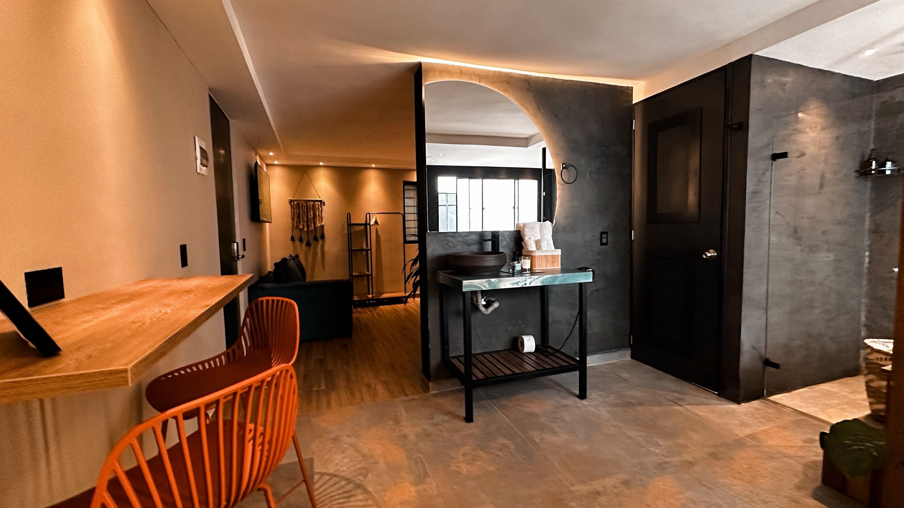 A modern kitchen with a wooden countertop, a sink, and a black cabinet.