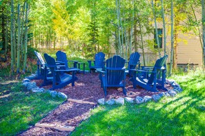 A garden with Adirondack chairs and a wooden deck. - Walk to Lifts & Main St | Hot Tub (Breckenridge)