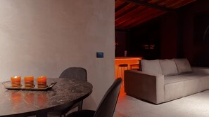 A modern interior with a dining table, chairs, a sofa, and a kitchen area. - Luxury loft urban (Medellín)