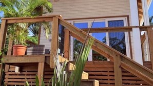 A wooden staircase leading to a building with a white facade and a sloped roof. - Conch Casitas - King or 2 Singles, AC, Shared Pool (Roatán)
