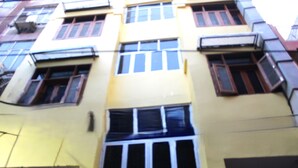 A multi-story building with several windows and balconies.