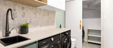 A modern kitchen with a built-in dishwasher and a sink.