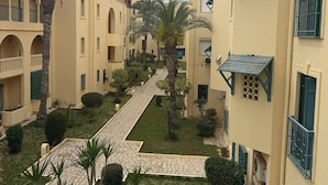 A courtyard with multiple buildings, each with balconies and a central pathway.