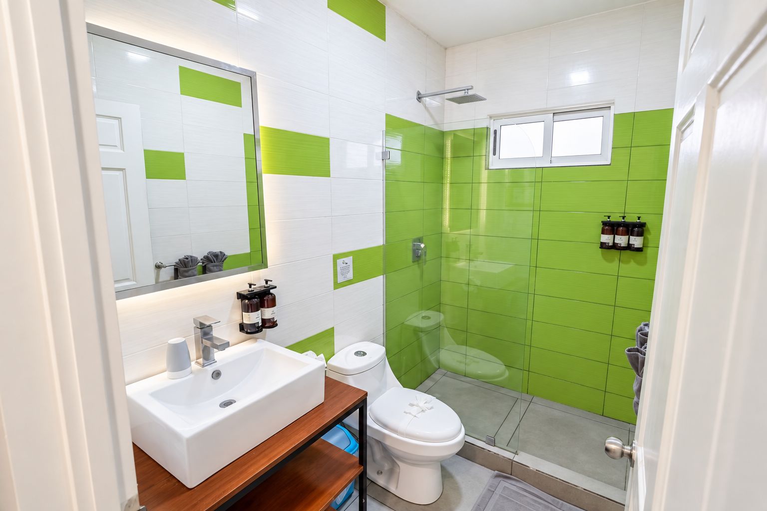 A bathroom with a white sink, a toilet, and a shower area.