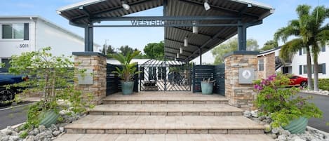 A gated entrance with a covered walkway leading to a building labeled 'WESTSHORE.'