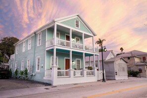 A two-story house with a balcony, a porch, and a garage. - Sombrero Reef Light Suite (Key West)