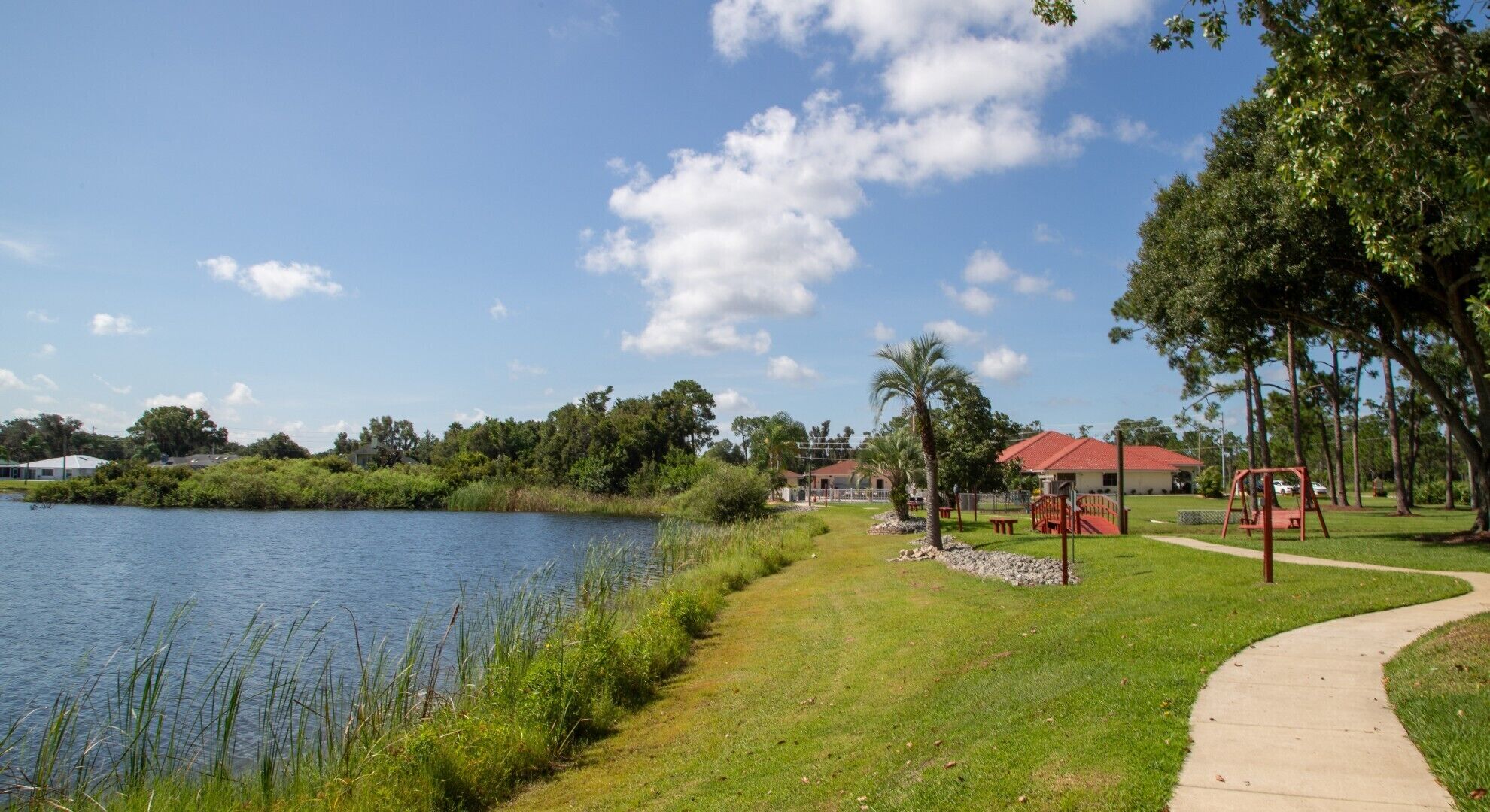 A park with a lake, walking paths, and a playground.