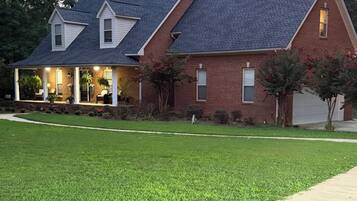 A two-story house with a covered porch and a garage.