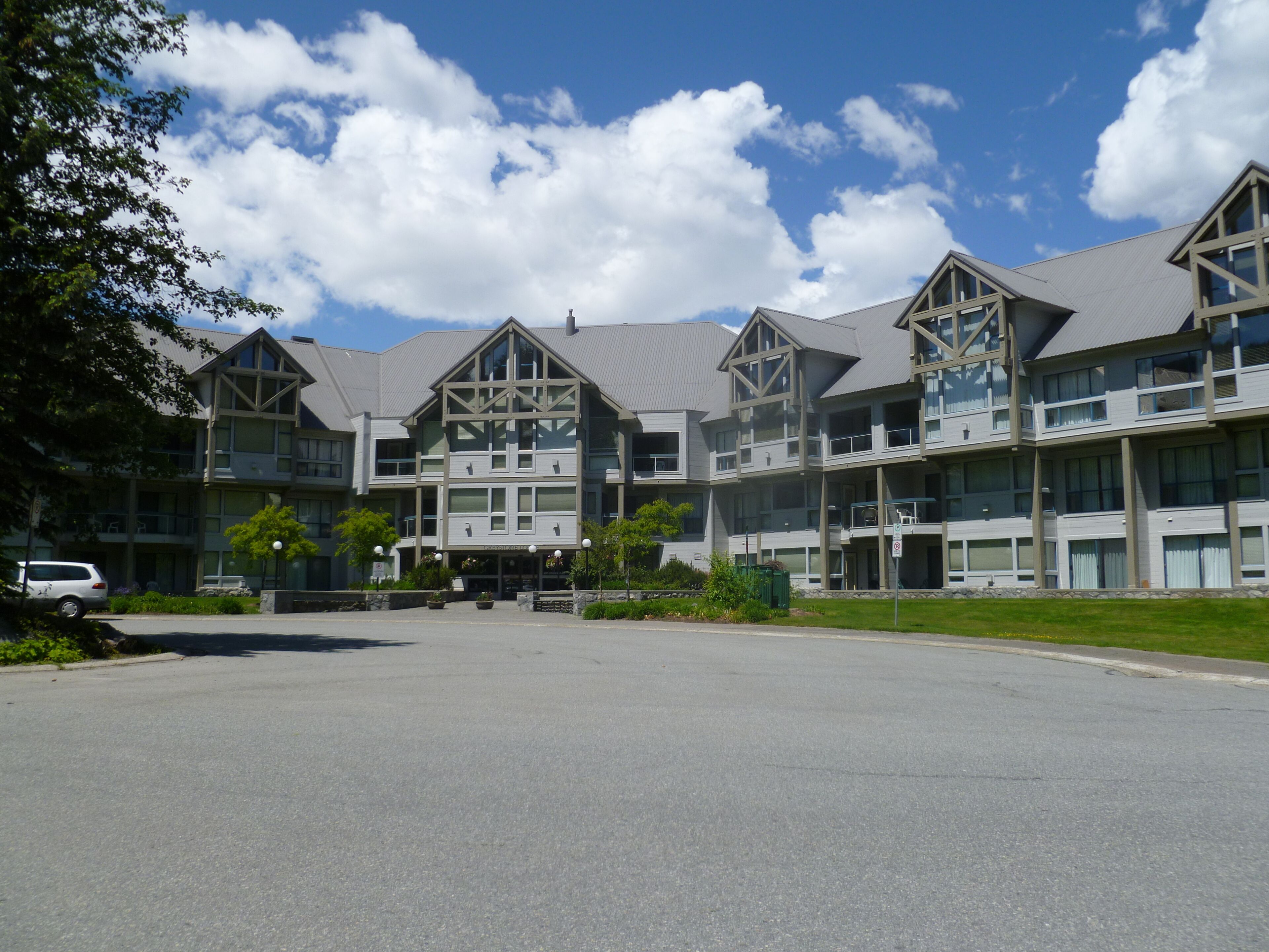 A multi-story hotel with a symmetrical facade, large windows, and a central entrance.