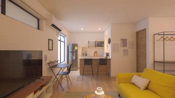 A modern living room with a flat-screen TV, a yellow sofa, and a kitchen area with a refrigerator and microwave.