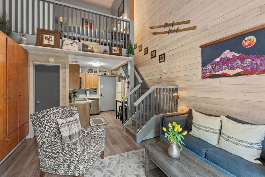 A multi-level living space with a staircase, a dining area, and a kitchen.