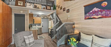 A multi-level living space with a staircase, a dining area, and a kitchen.