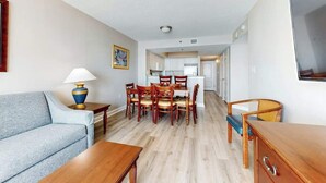 A compact living space with a dining area, kitchenette, and a sofa. - Carolinian Beach Resort 1030 (Myrtle Beach)