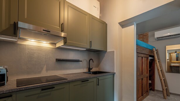 A modern kitchen with a built-in stove, a sink, and a range hood.