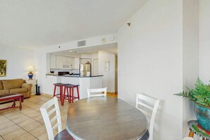 A compact living space with a dining area, kitchenette, and a sofa. - Carolinian Beach Resort 1036 (Myrtle Beach)
