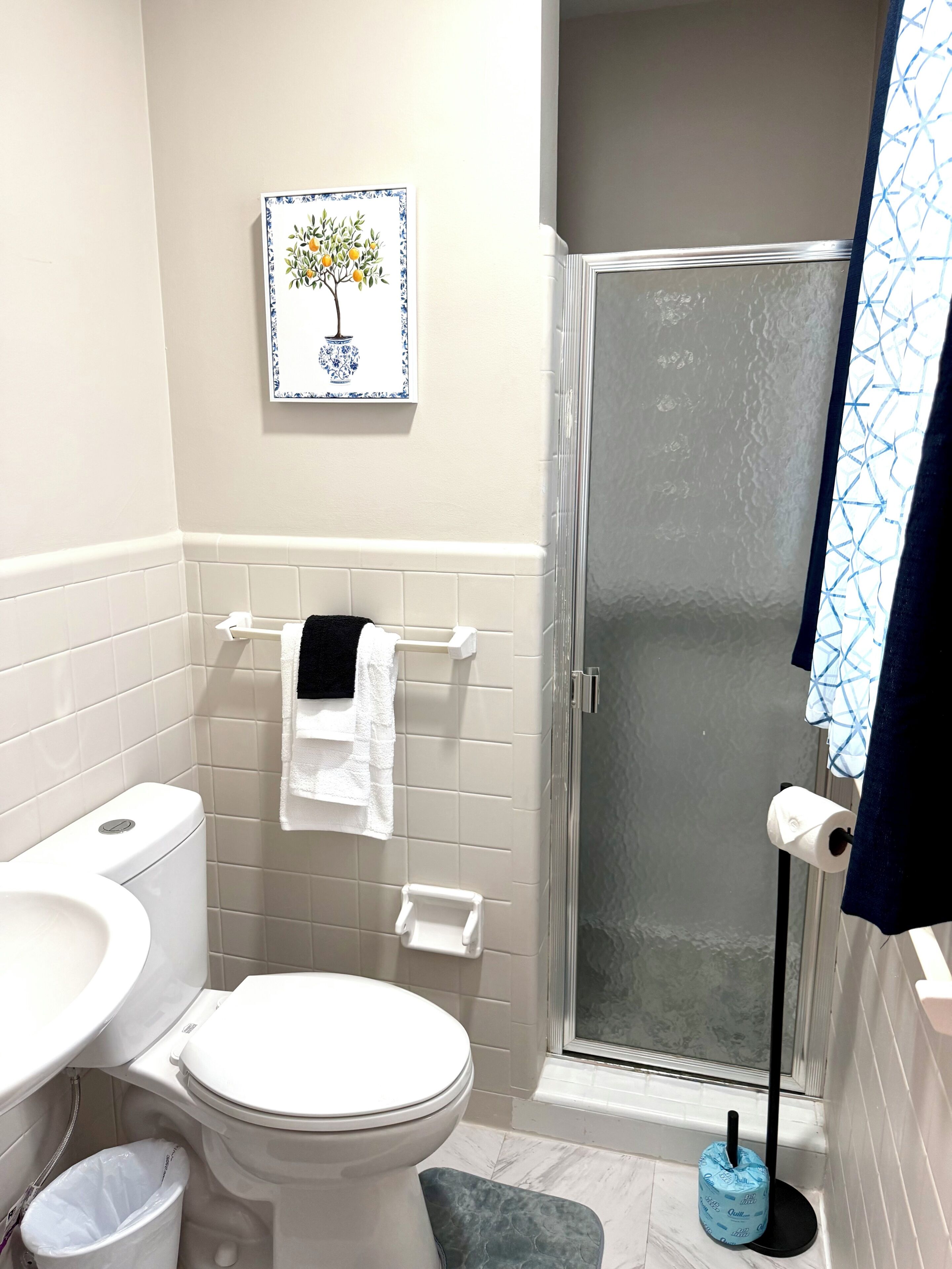 A bathroom with a toilet, bidet, and shower.