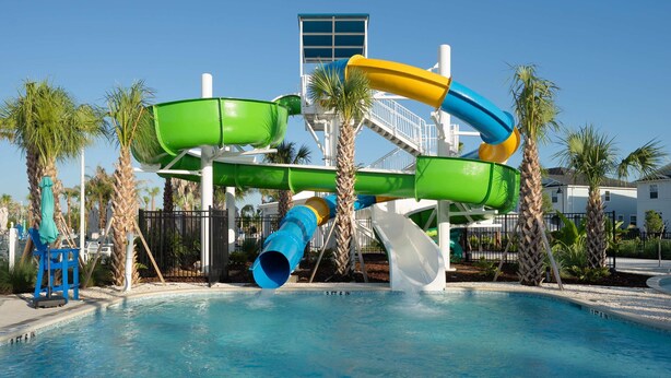A water park with multiple slides and a pool. - Luxury 8BR Themed Villa With Private Pool (Clermont)