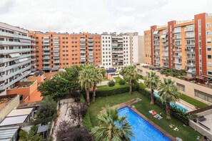 A residential building with multiple balconies, a swimming pool, and surrounding greenery. - 6CBADR1141 Apartment near the beach &swimming pool (Barcelona)
