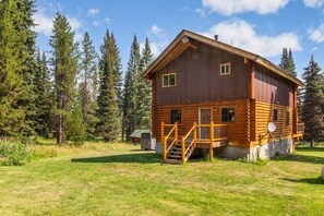 A log cabin with a wooden exterior, a front porch, and a small attached shed. - Aspen Pond Retreat | 7 Mi to YNP | Private Pond (West Yellowstone)