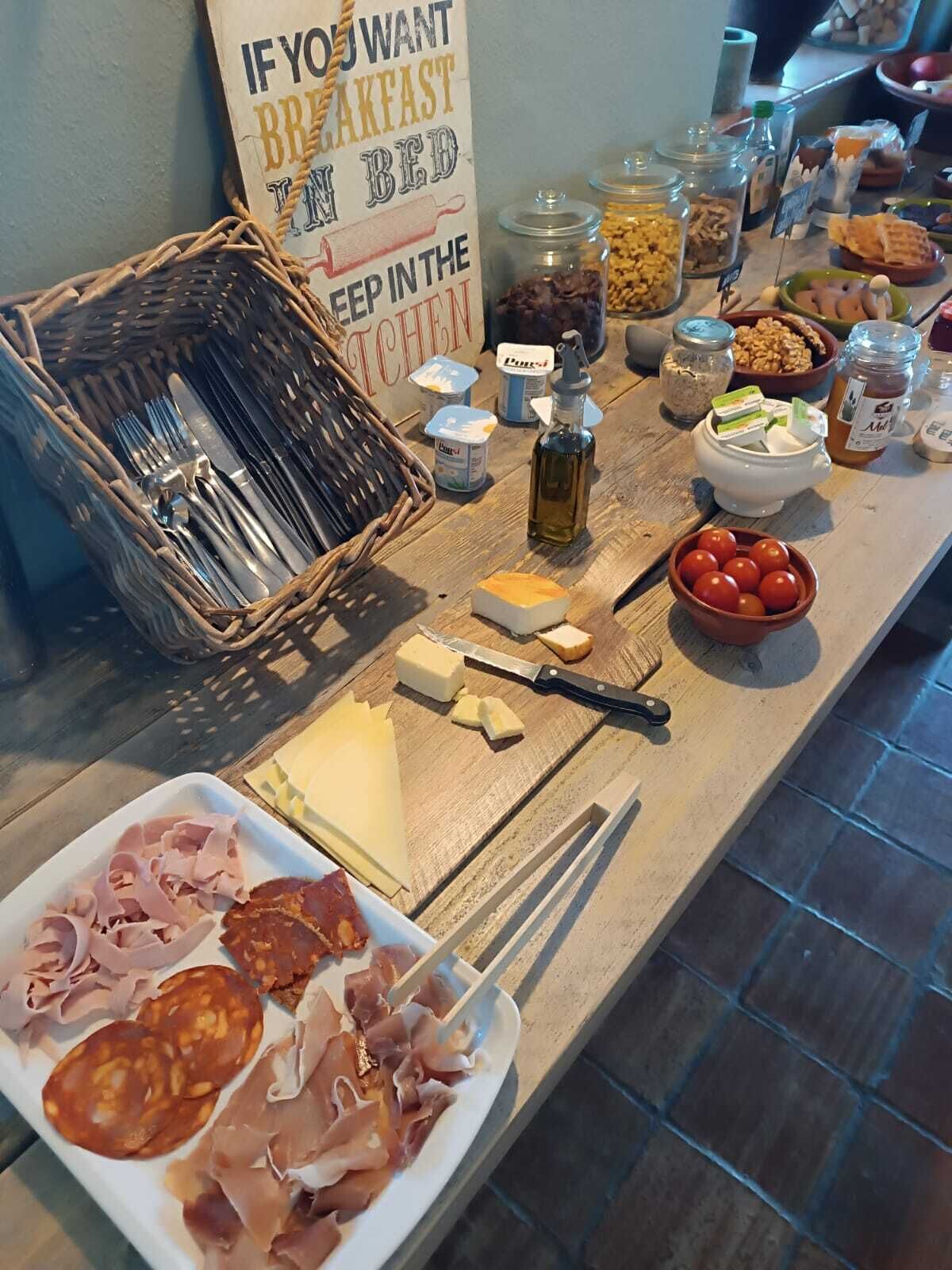 A breakfast buffet with various food items and condiments.