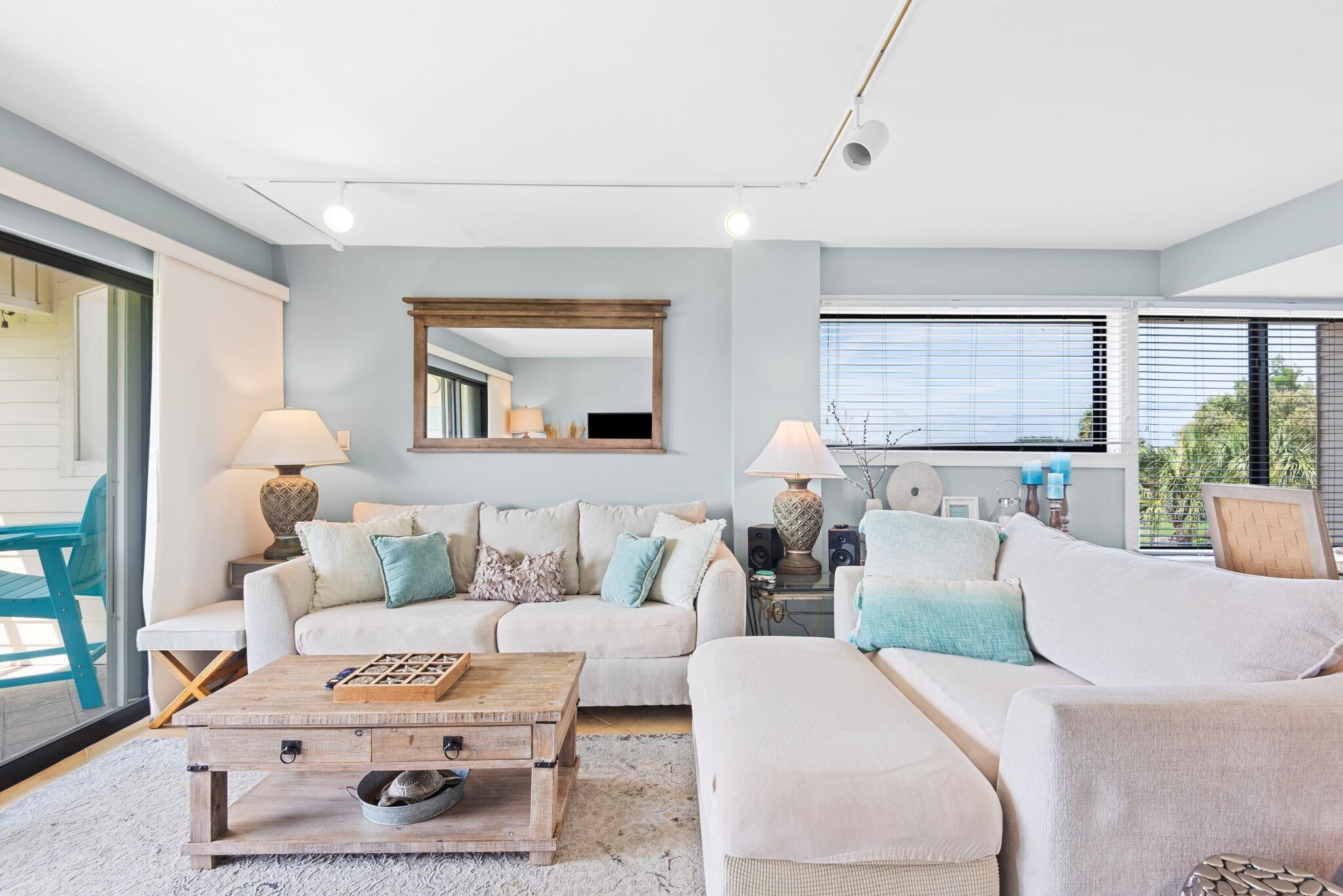 A modern living room with a sofa, coffee table, and lamps.