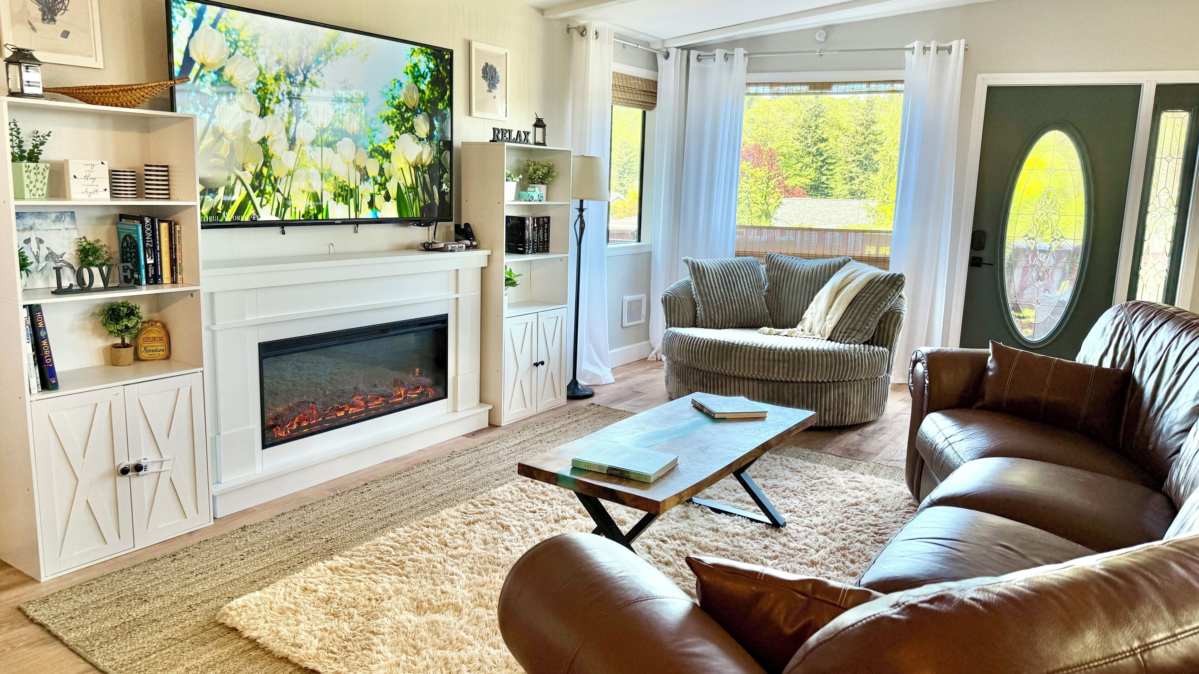 A living room with a fireplace, a television, a sofa, and a coffee table.