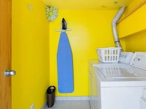 A laundry area with a washing machine, a drying rack, a trash bin, and a laundry basket. - Serene + Spacious Boulder Oasis | Sleeps 10 | 30+ (Boulder)