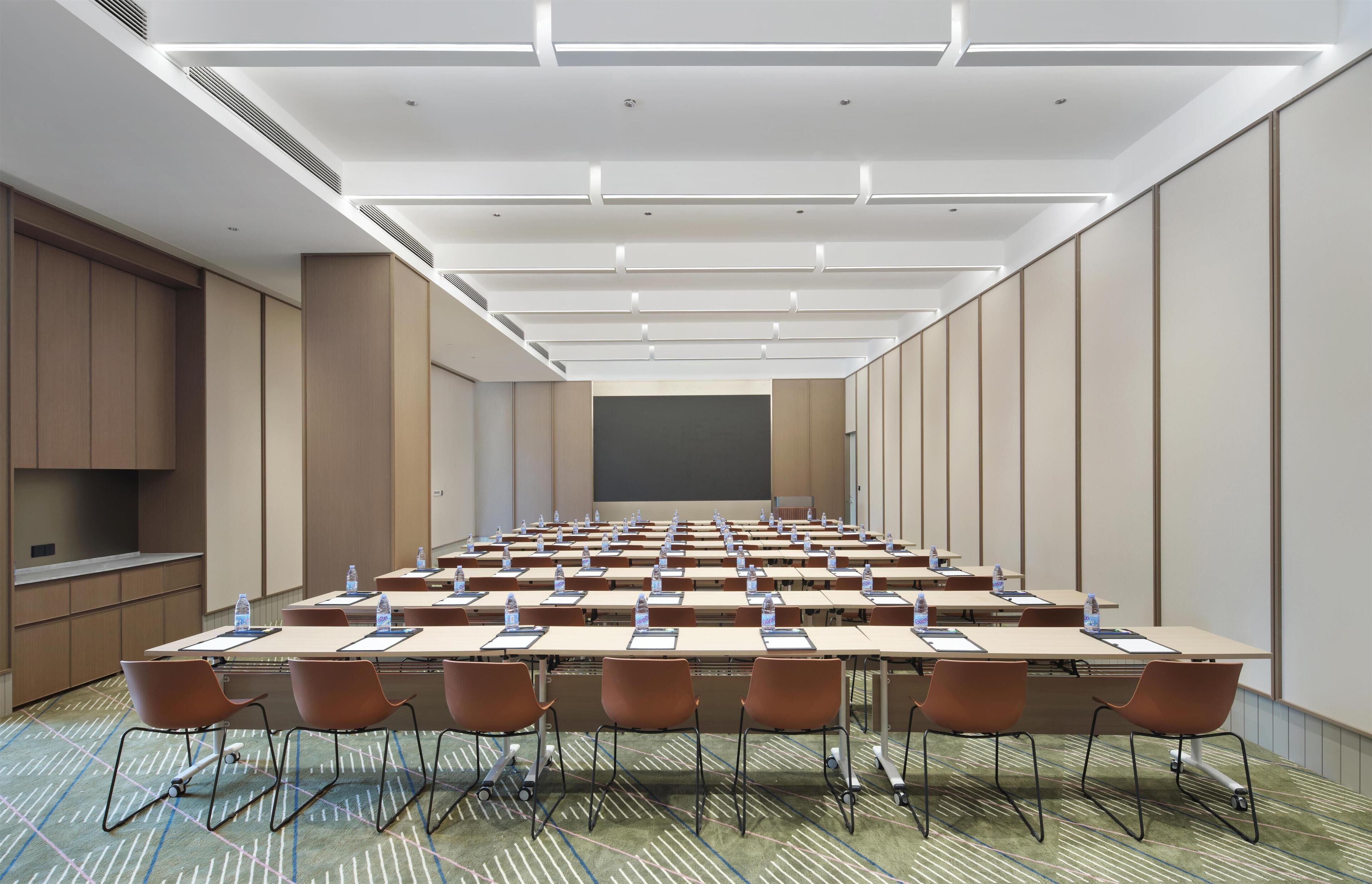 A conference room with a long table, chairs, and water bottles.