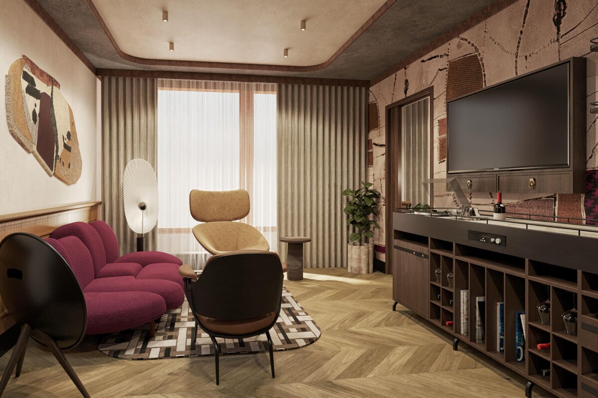 A modern living room with a sofa, chairs, a TV, and a wine rack.
