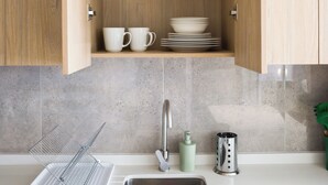 A kitchen with wooden cabinets, a stainless steel sink, and a countertop with a dish rack. - Inés Matte Urrejola Apartments by Andes STR (Providencia)