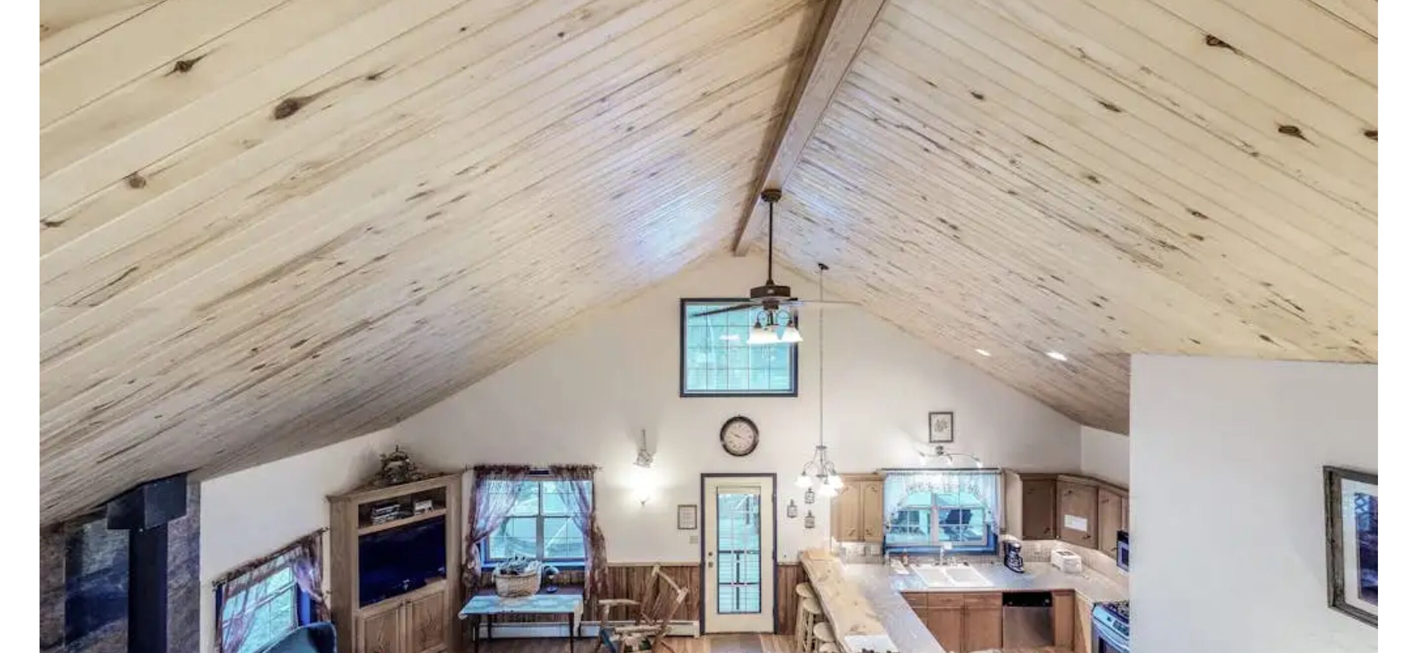 High-angle view of the vaulted wood ceiling over the living room and kitchen.