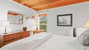 A bedroom with a bed, dresser, mirror, window, and a framed picture on the wall. - Cozy 2 Bedroom Condo in Silverthorne, CO! (Silverthorne)