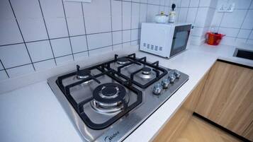 Deluxe Apartment, Pool View | Private kitchen | Full-size fridge, microwave, oven, stovetop