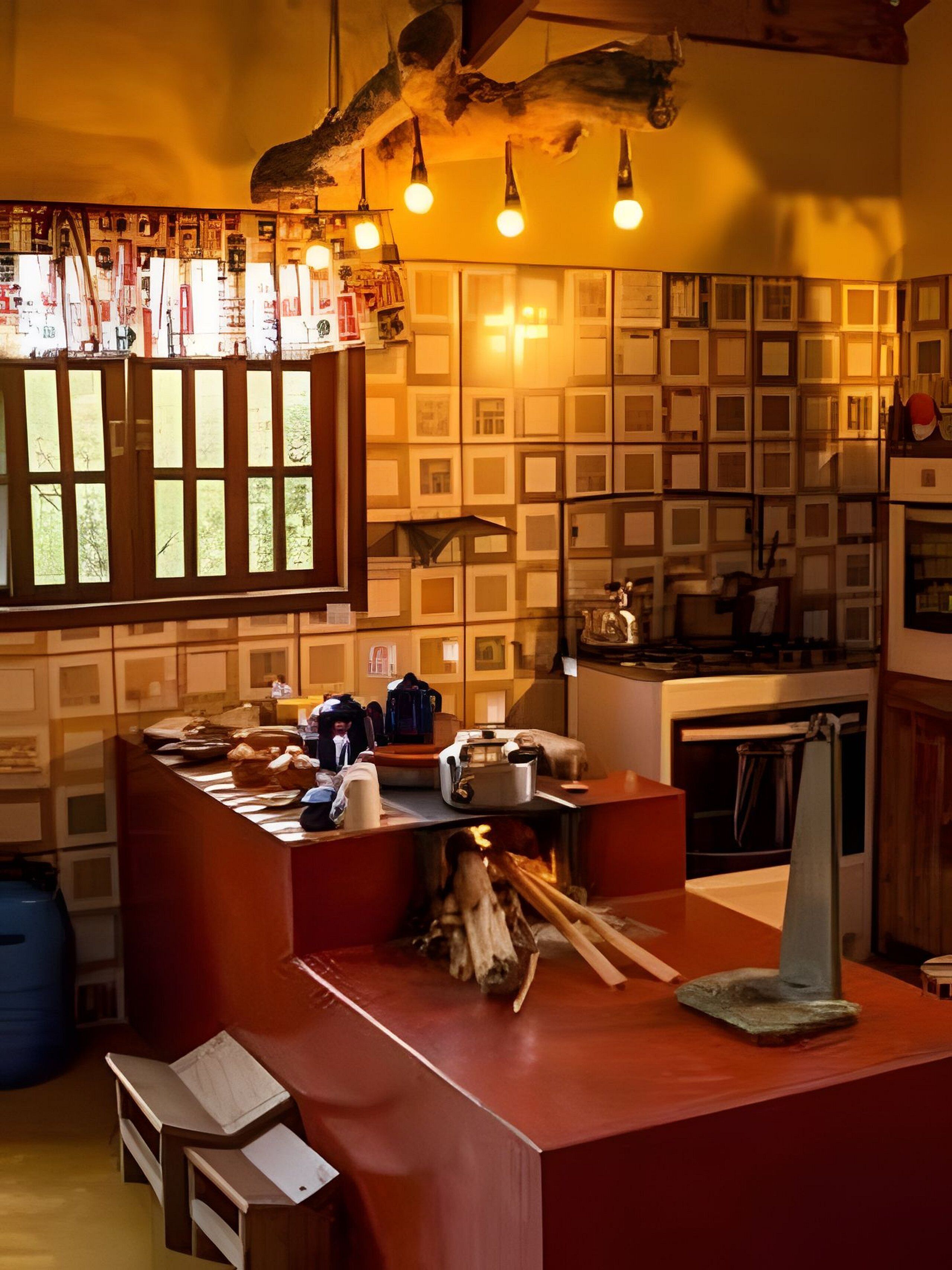 A kitchen with a central island, wooden cabinets, and a hanging light fixture.