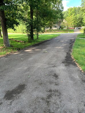 A paved pathway in a park with trees on both sides. - Spacious 6-bedroom house with AC in soothing POCONO MOUNTAINS (Saylorsburg)