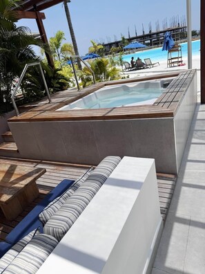 A pool area with a hot tub, lounge chairs, and a wooden deck. - Exclusive, Panoramic Terrace, and Dreamlike Views (Cartagena Province)