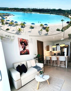 A modern living room with a view of a beach and pool. - Exclusive, Panoramic Terrace, and Dreamlike Views (Cartagena Province)