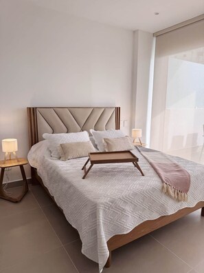 A modern bedroom with a large bed, two bedside tables, and a view of the outside. - Exclusive, Panoramic Terrace, and Dreamlike Views (Cartagena Province)