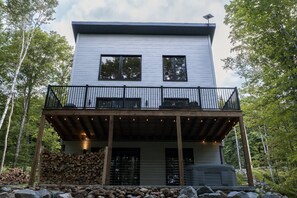 A modern two-story building with a balcony and a covered outdoor area. - Spa, Comfort & Escape | ASKA (Saint-Côme)