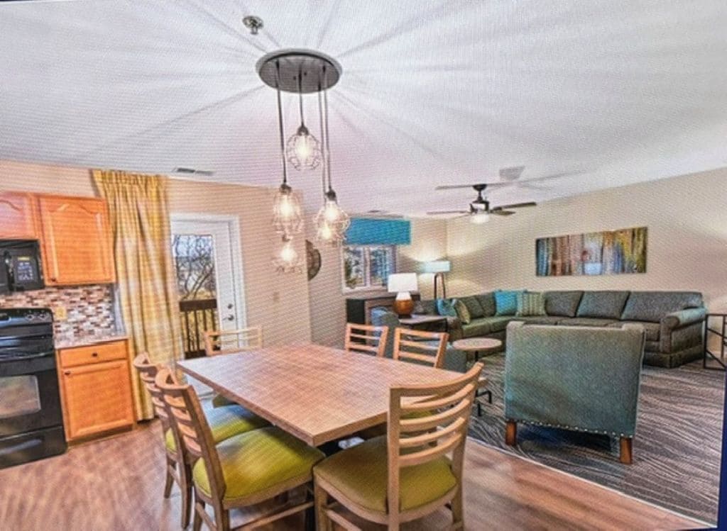A compact living space with a dining area, kitchen, and seating area.